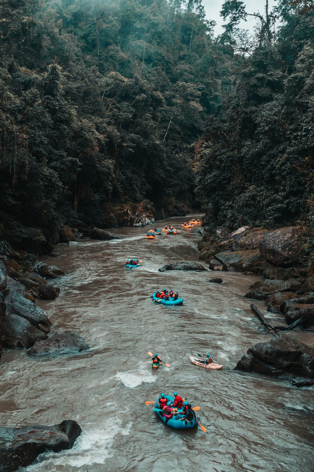 Descenso en grupo por un río encajonado entre bosque